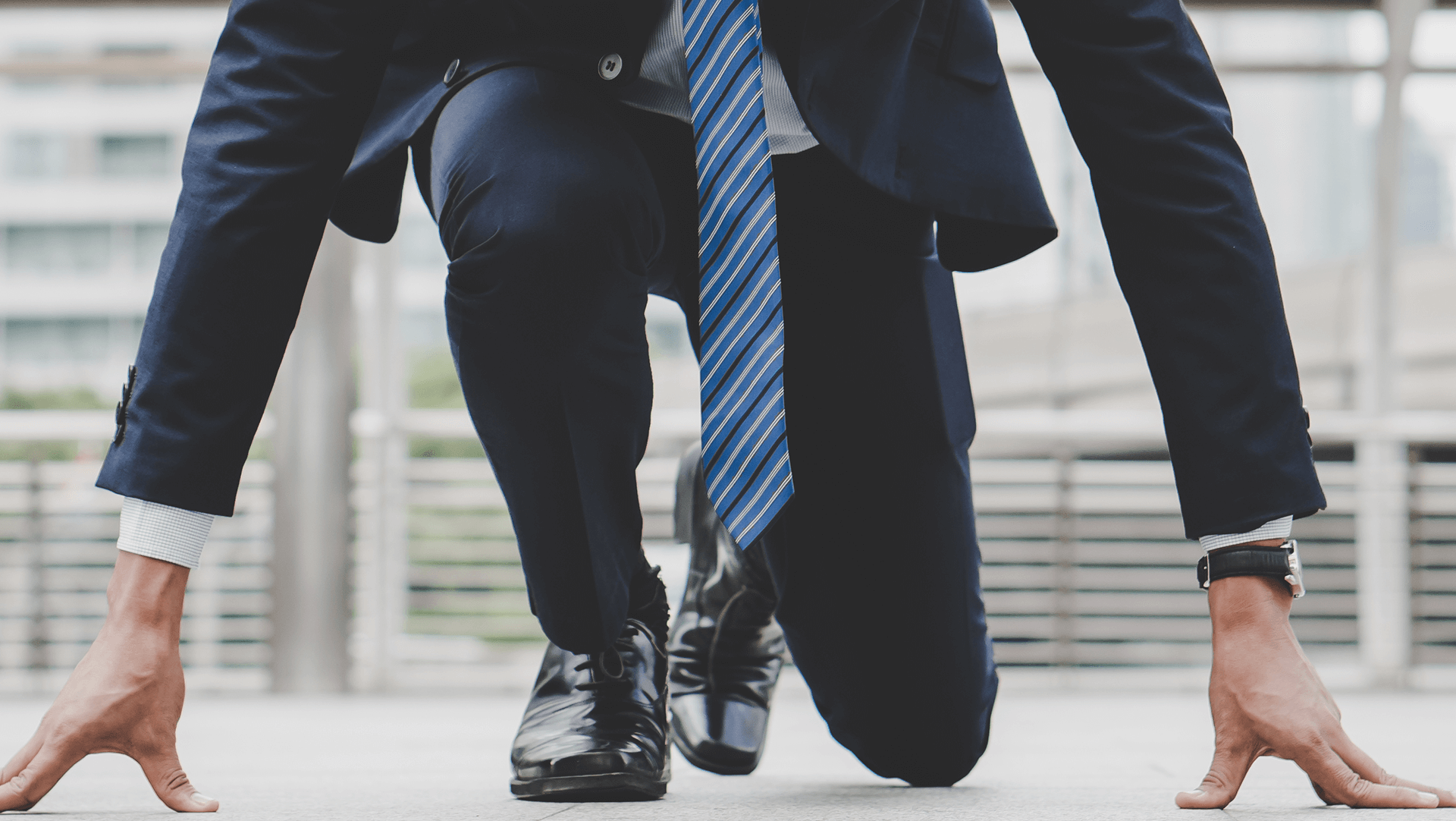 A professional in a suit and tie poised at the starting line, metaphorically ready to race ahead in the corporate world.