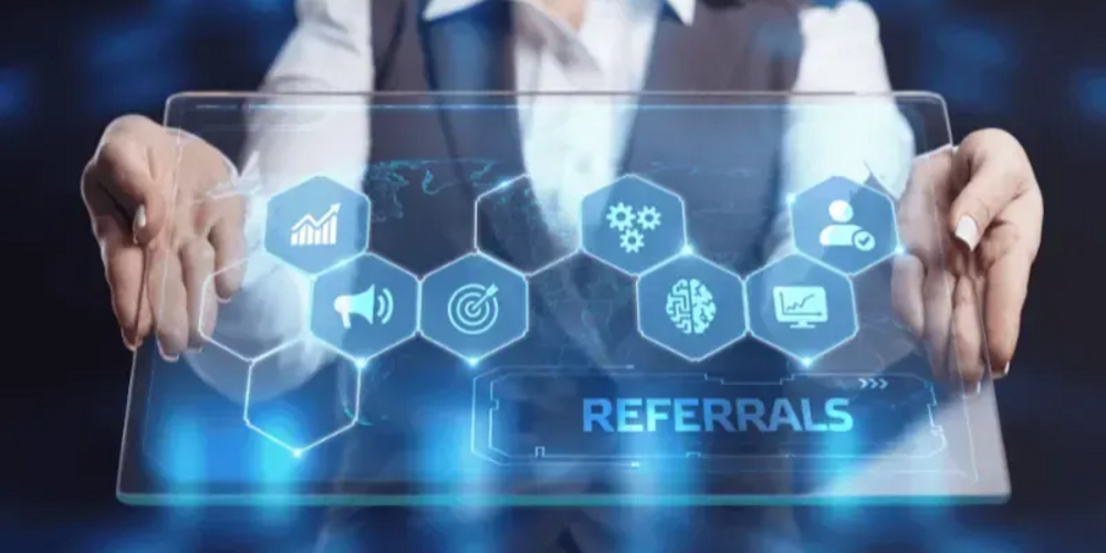 A professional interacting with a futuristic holographic interface displaying various business-related icons and a highlighted section labeled "referrals.